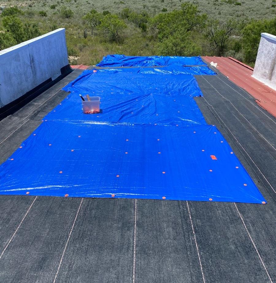 Blue tarp secured to a flat roof