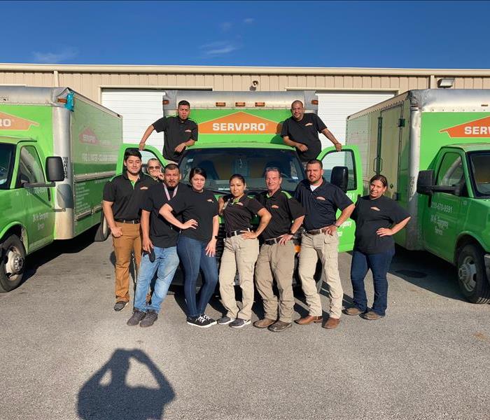 the entire crew of servpro alamo ranch standing outside in front of a SERVPRO truck 